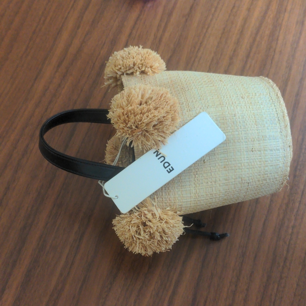 Edun pom pom bucket raffia bag